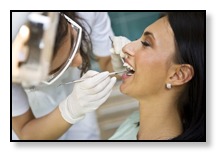 Woman having TMJ Pain exam by neuromuscular dentist