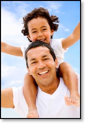 young boy smiling while riding on fathers shoulders beautiful smiles